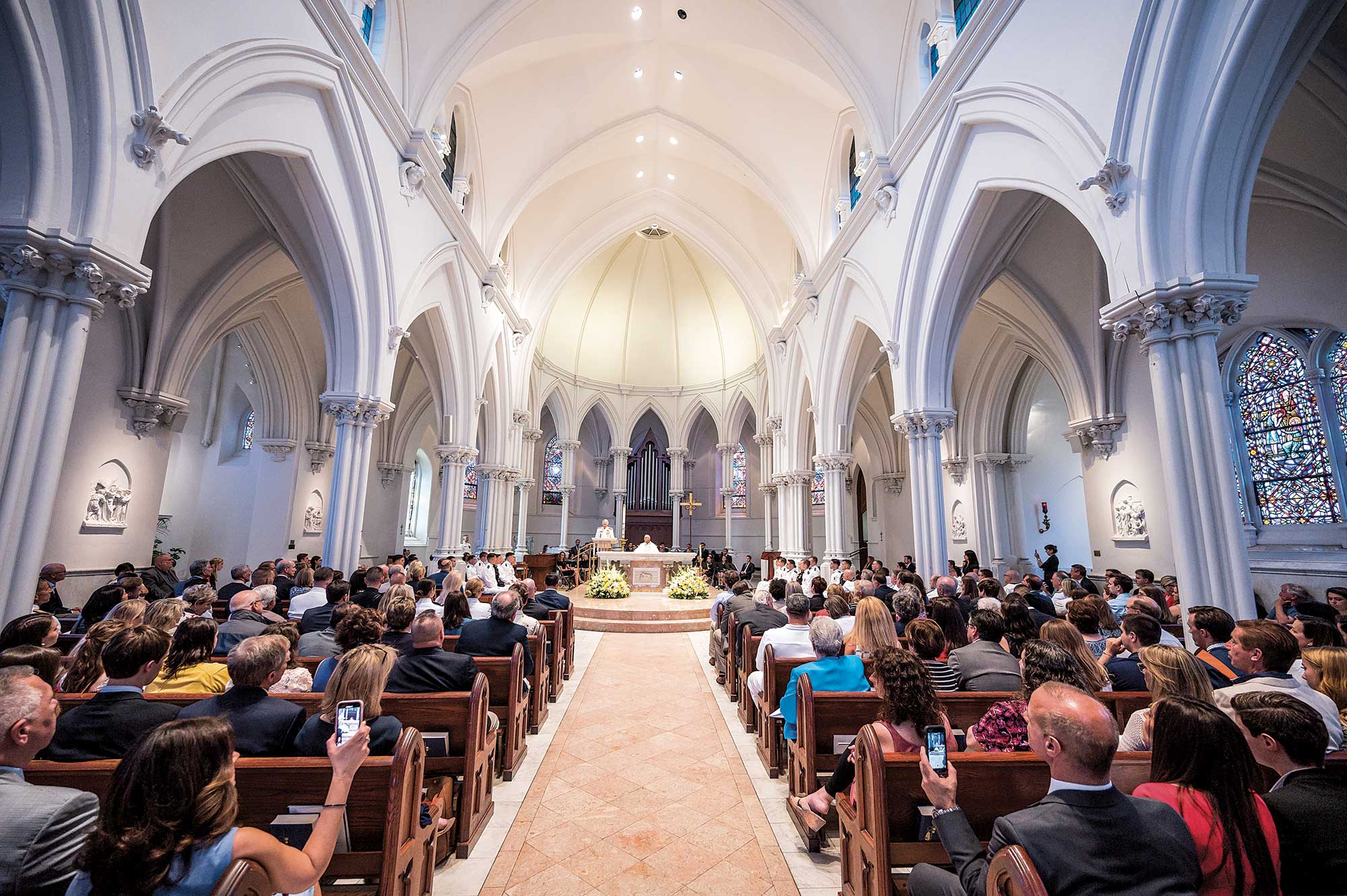 Interior of St. Thomas of Villanova Church, with bright white arched ceilings