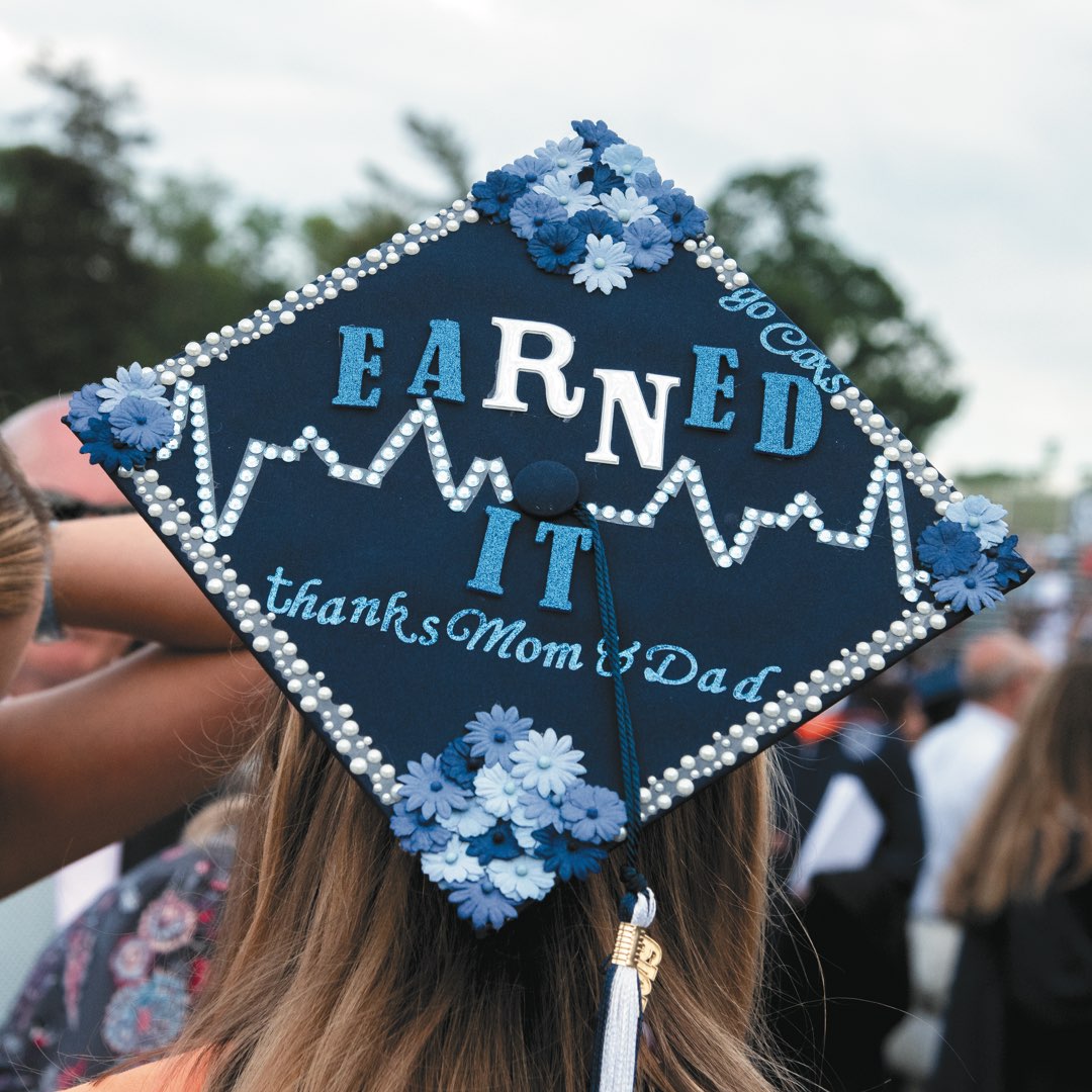 Jeweled and flowered cap that reads “Earned it. Thanks Mom & Dad”