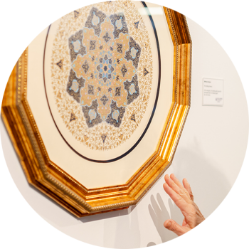 Person gesticulating in front of an art piece