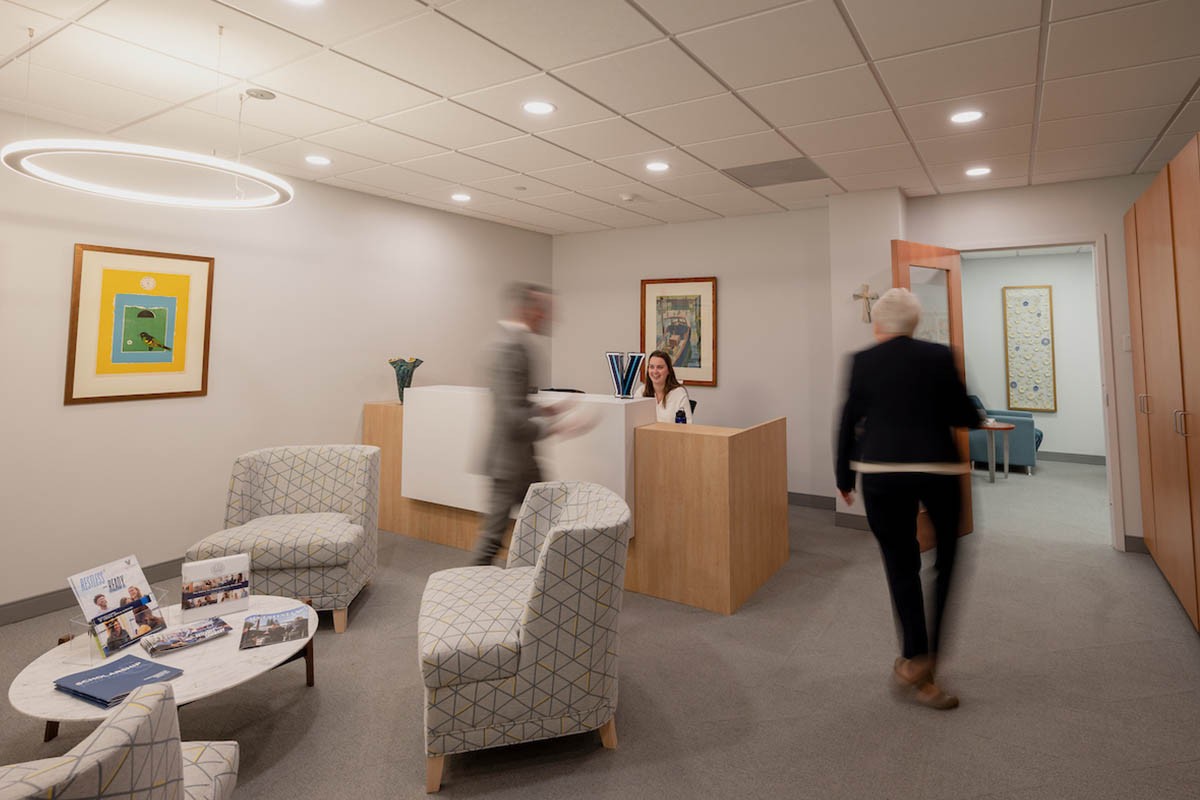 Blurred individuals walking through an office