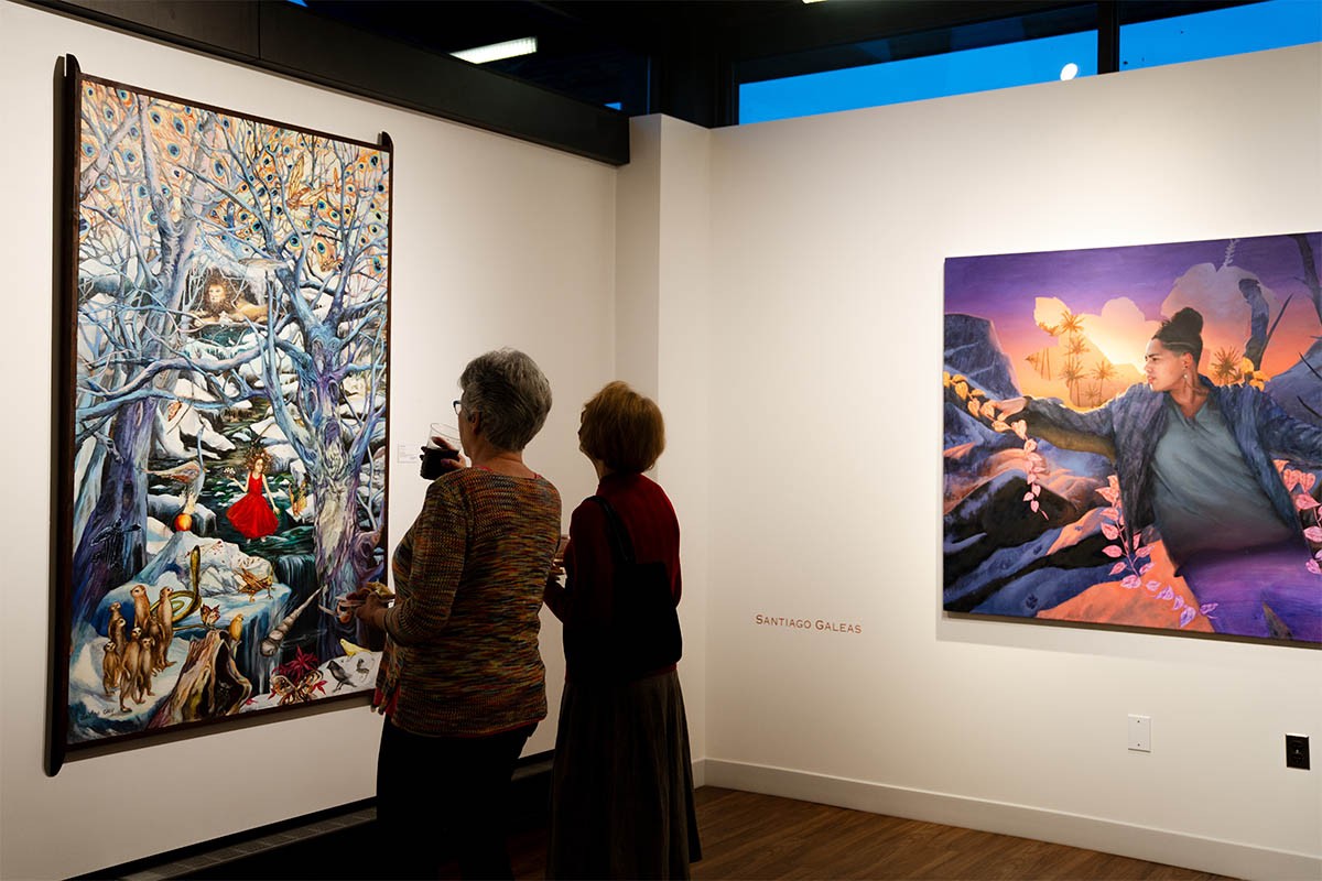 Two women looking at an art piece together