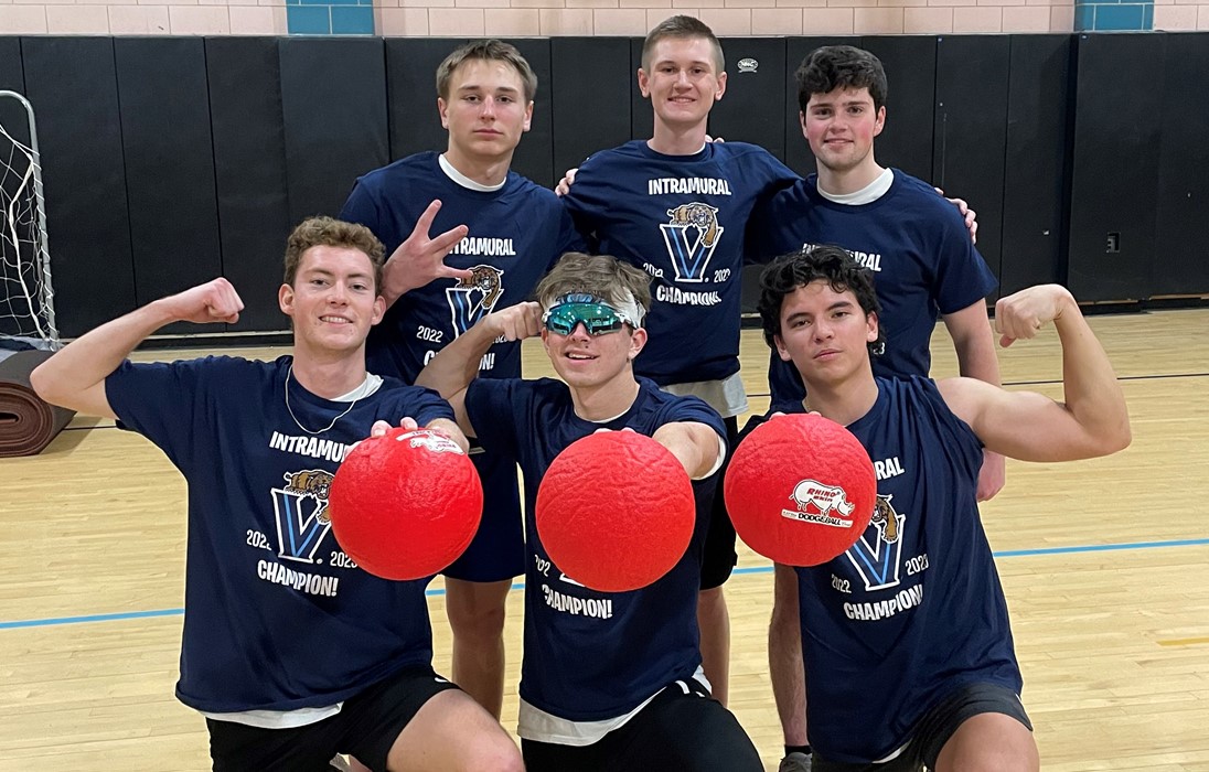 Male students posing for handball champion photo