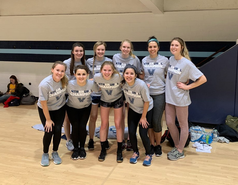 Female students posing for indoor volleyball champion photo