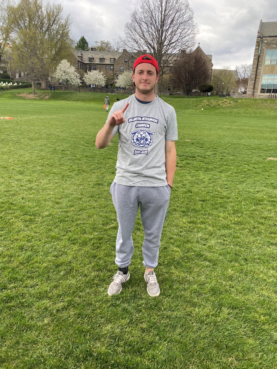 Male student posing for singles tennis champion photo