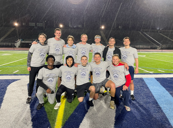 Male students posing for ultimate frisbee champion photo