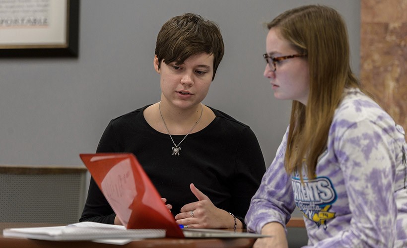 A student get's tutoring help in the library.
