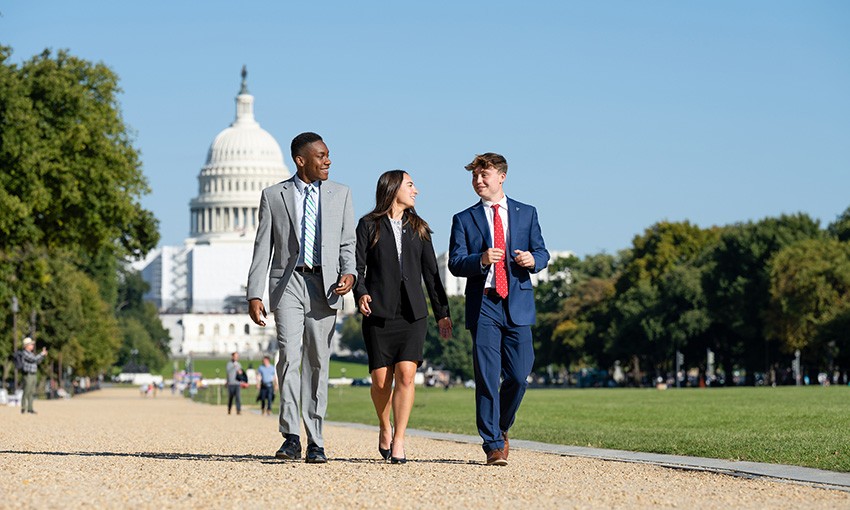 Three students walk in Washington, D.C., during an immersion trip.
