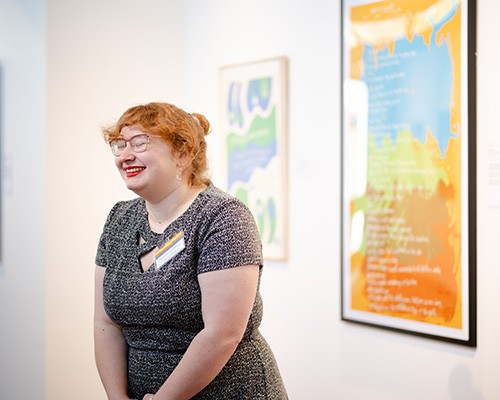 Patrons look at a piece at the exhibit, "Abstract Activism: Sam Maitin's Philadelphia."