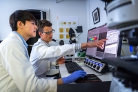 Biology graduate student and faculty using advanced imaging technology