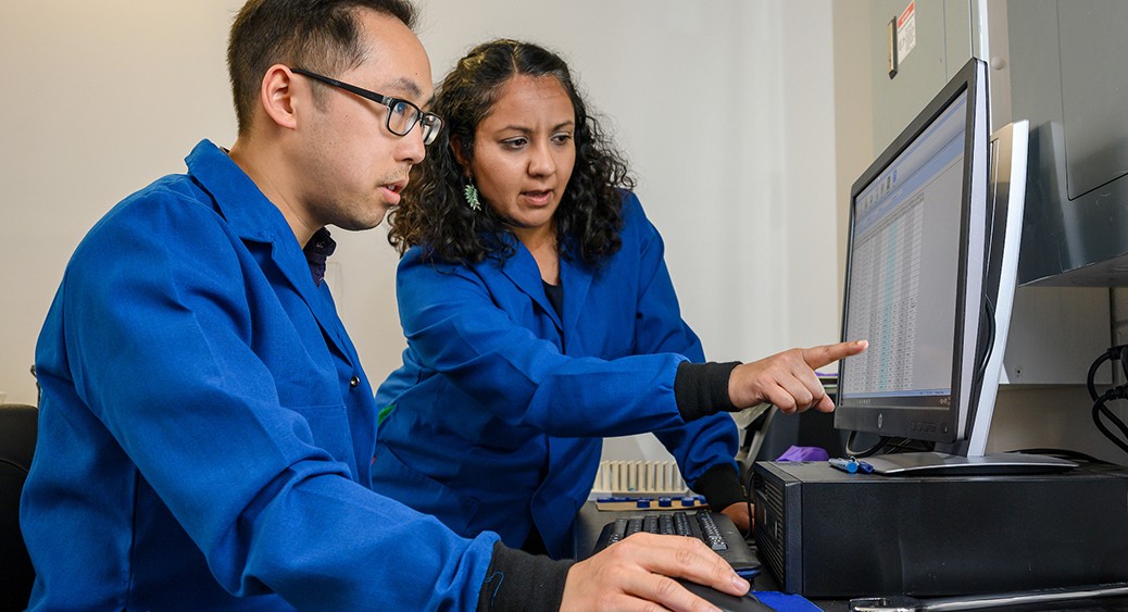 A graduate student and faculty advisor analyze data in an environmental science lab. A graduate student and faculty advisor analyze data in an environmental science lab.