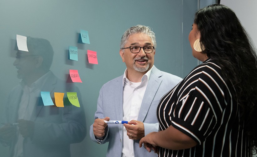 UNITAS: INCLUSIVE EDUCATION Edward Fierros, PhD, associate dean UNITAS: Inclusive Education, talks with a student.