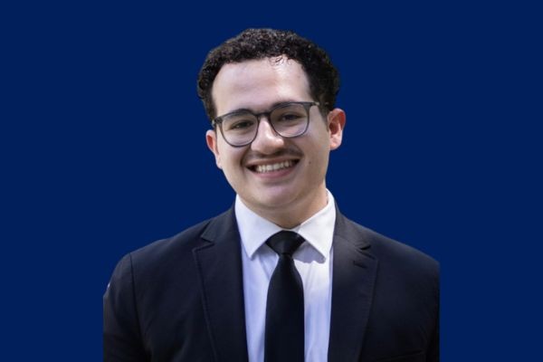 Daniel Gueyikian '25 is the 2025 recipient of the Robert Langram Service Award. Political Science student being presented with award by professor.