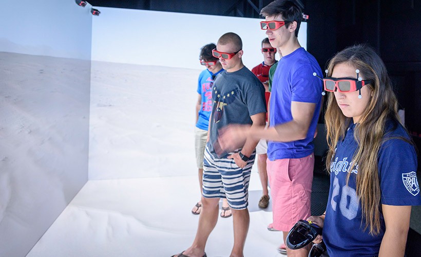 image of students wearing VR glasses in front of a desert backdrop