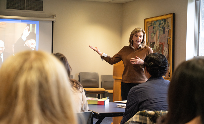 A woman teaching a History class. History class.
