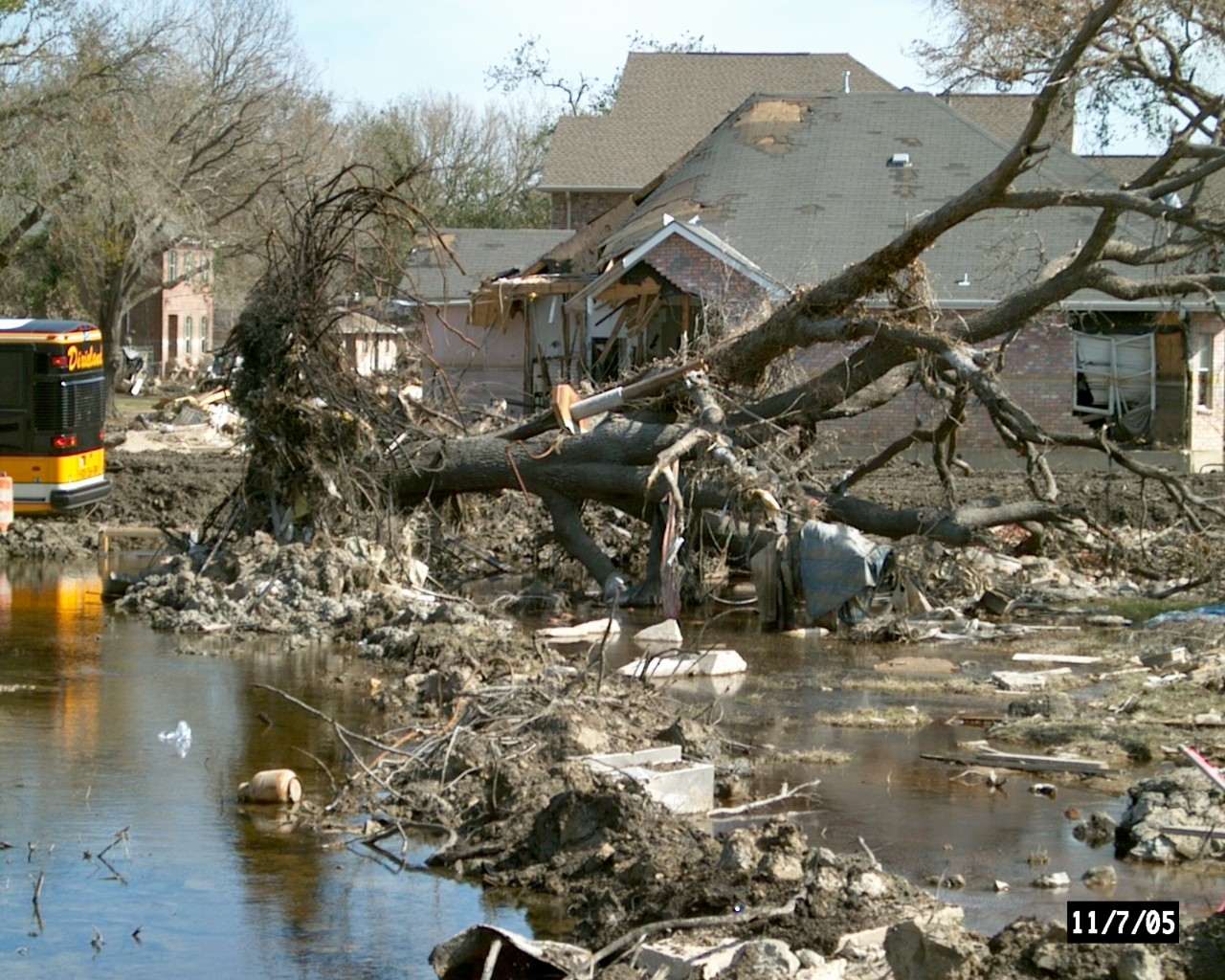 Destruction to a home by flooding and a downed tree.