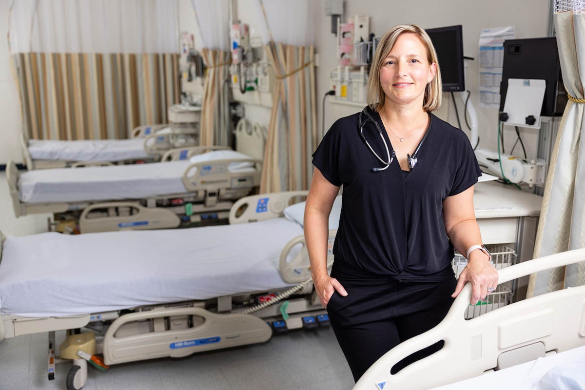 A nurse standing bedside with a stethoscope around her neck