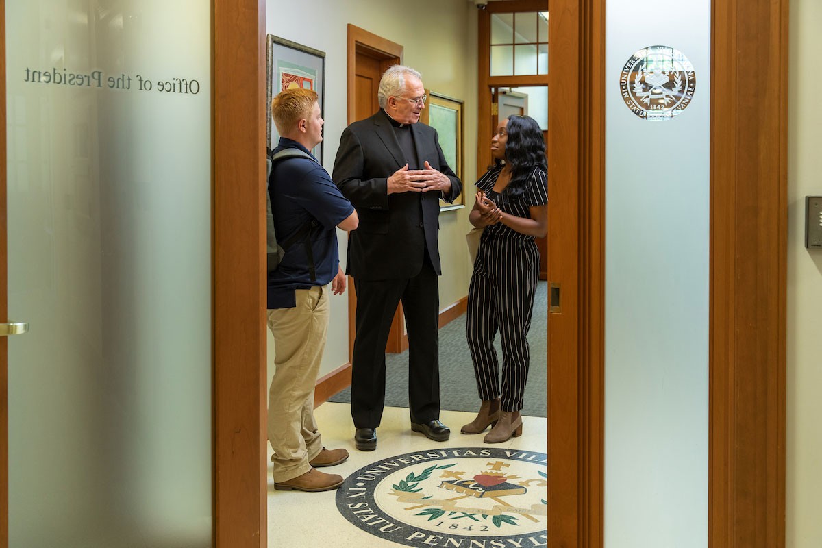 UCM052_20190626-0004-Edit Father Peter Donohue, Villanova President, meets with students in his office.