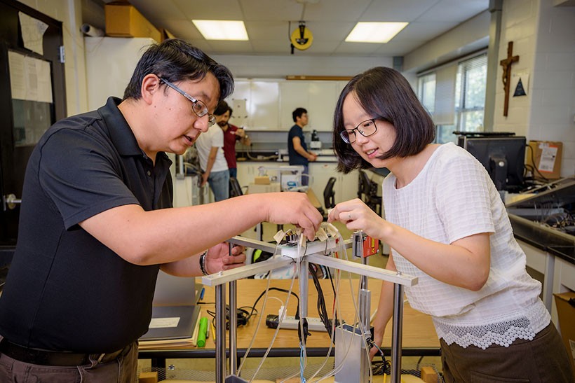Faculty working together in lab