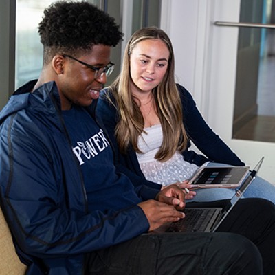 SLLC-cabrini-3 students looking at a laptop