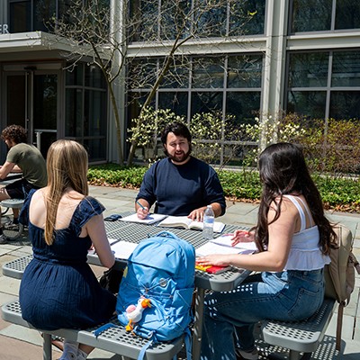 SLLC-cabrini-2 students sitting outside at a table