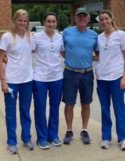 Kelly Montesi far left_Greenwich Hospital 2021 Flynn Fellows with Fred Flynn 3 nursing students in scrubs stand outside with donor Fred Flynn
