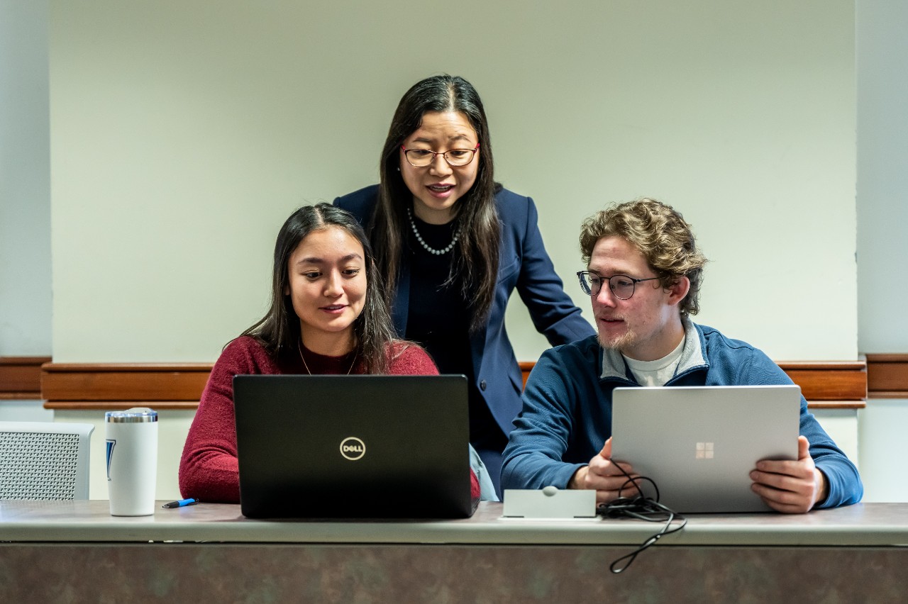 teacher collaborating with students 