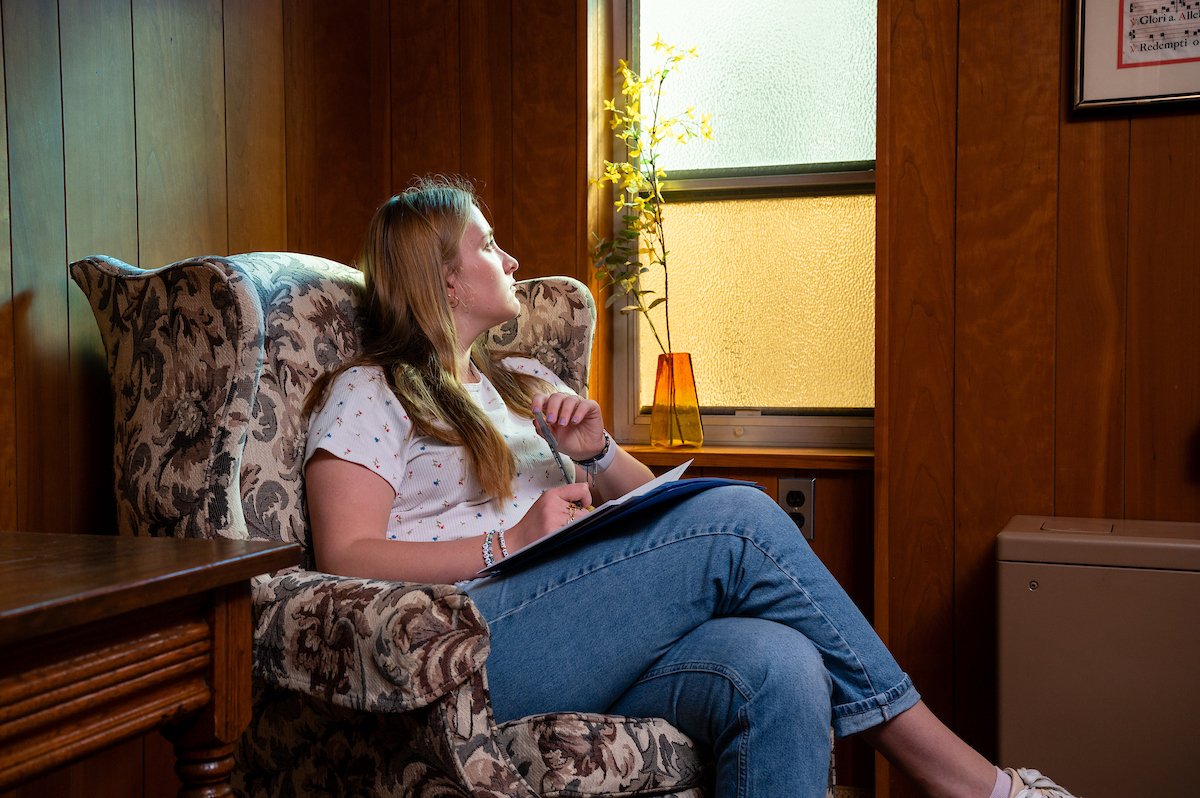 Students listening on a couch