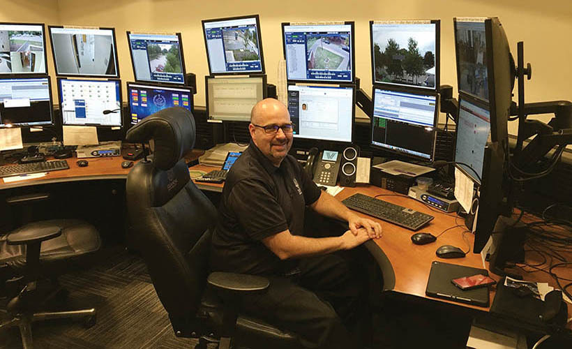 Uniformed Villanova officer in Public Safety control room.
