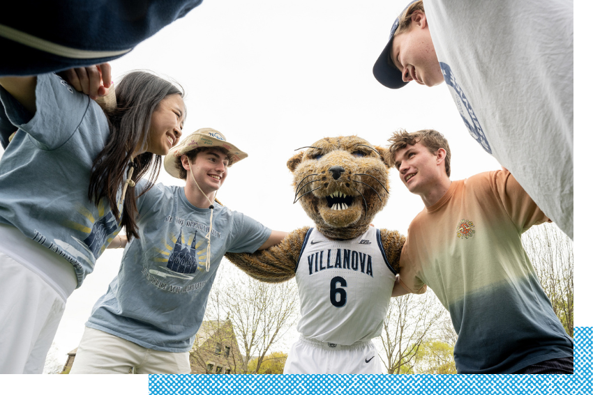 Orientation counselors huddling with Villanova's mascot, Will D. Cat.