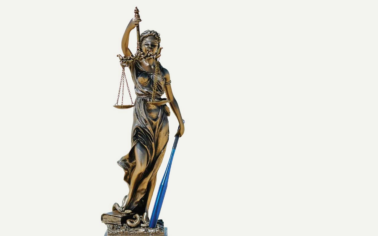 A statue of Lady Justice holding a blue Villanova baseball bat.
